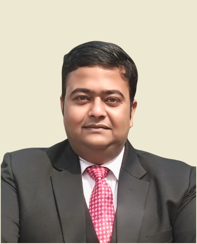 a man in dark suit, pink tie and combed hair looking in front